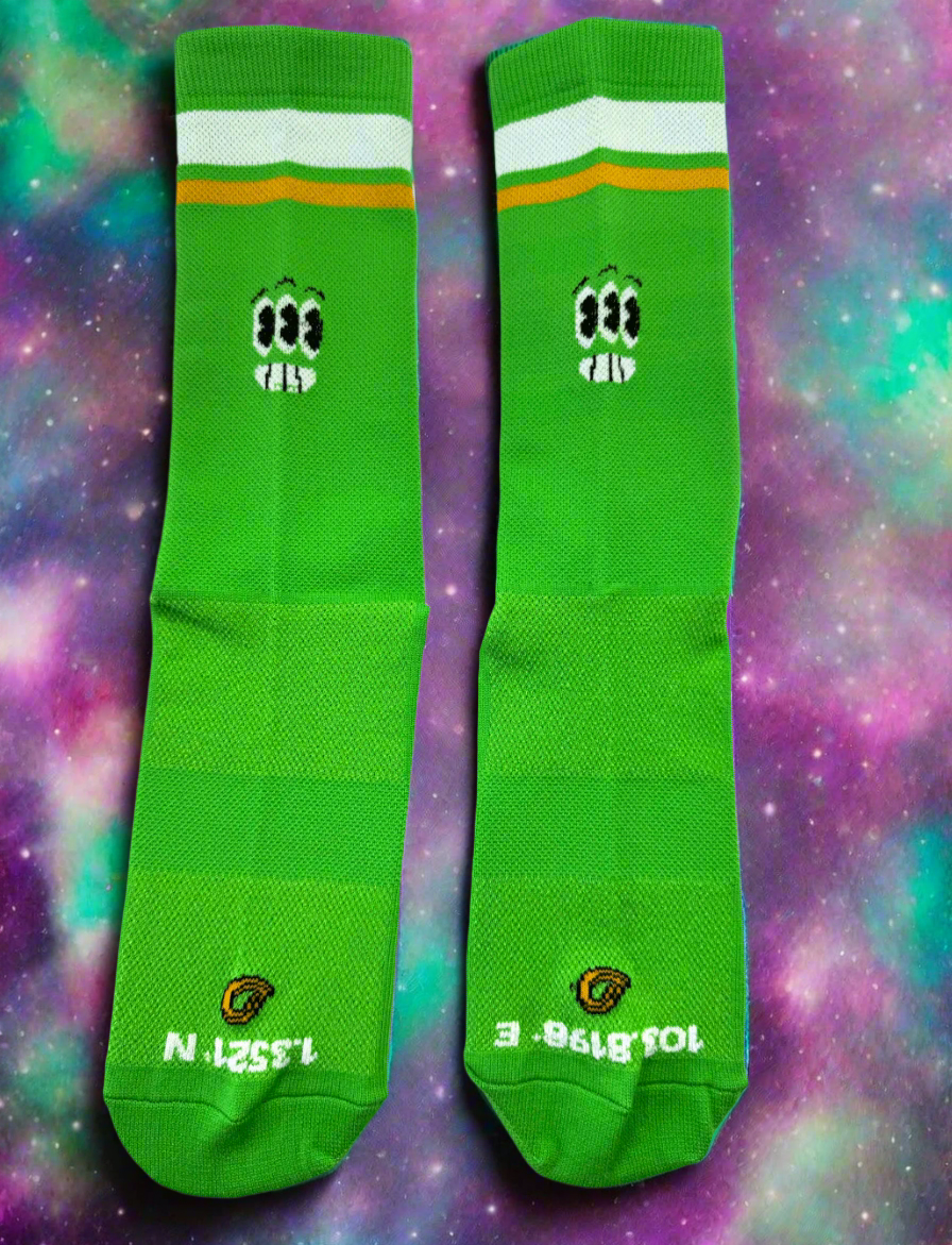 a pair of bright green socks with cute alien expresions on the front